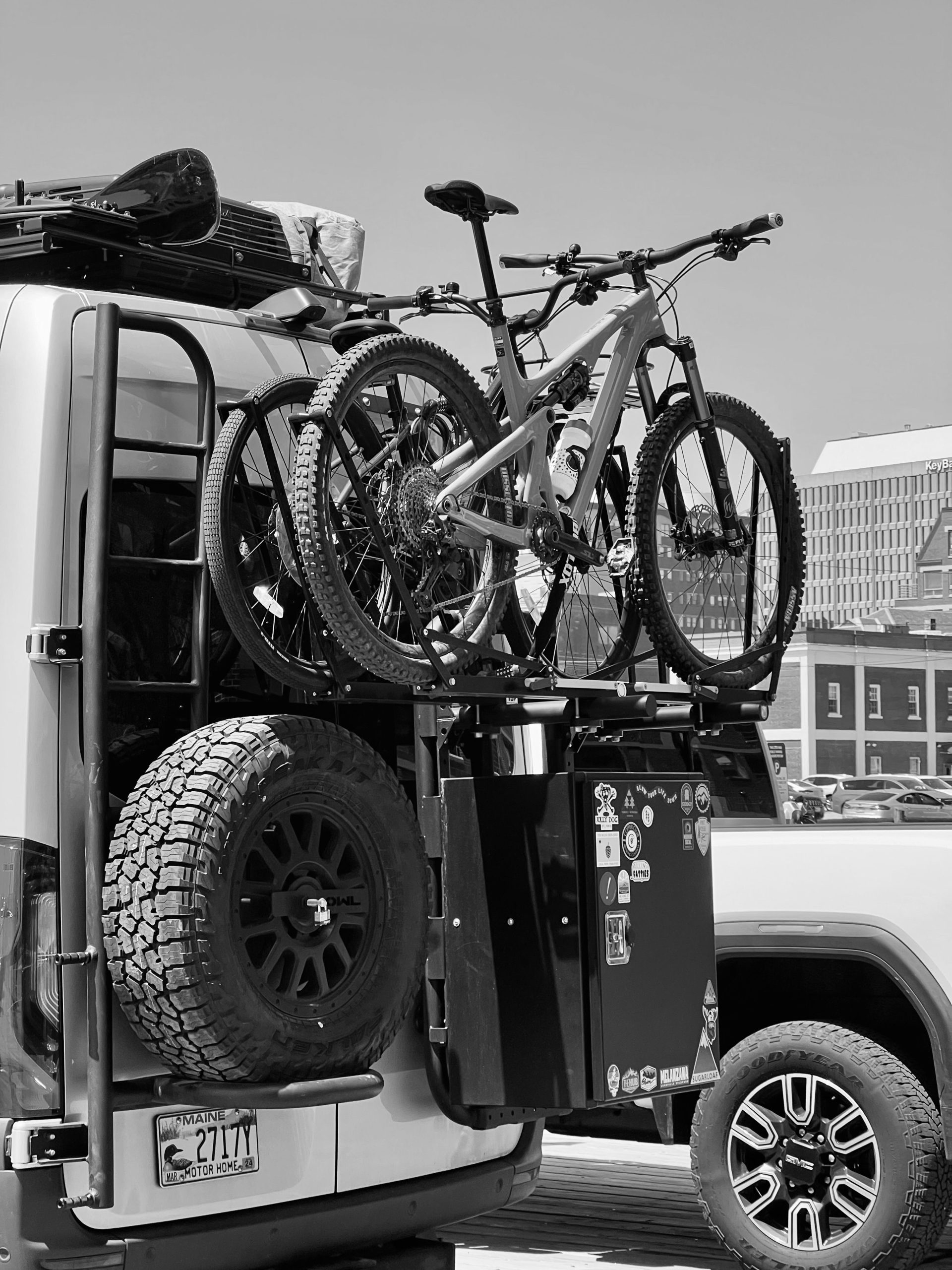 Bicycles mounted on a vehicle bike carrier in an outdoor setting