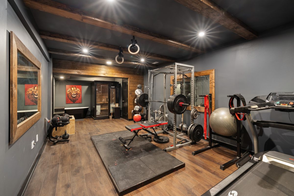 Bright home fitness space with treadmill and workout equipment
