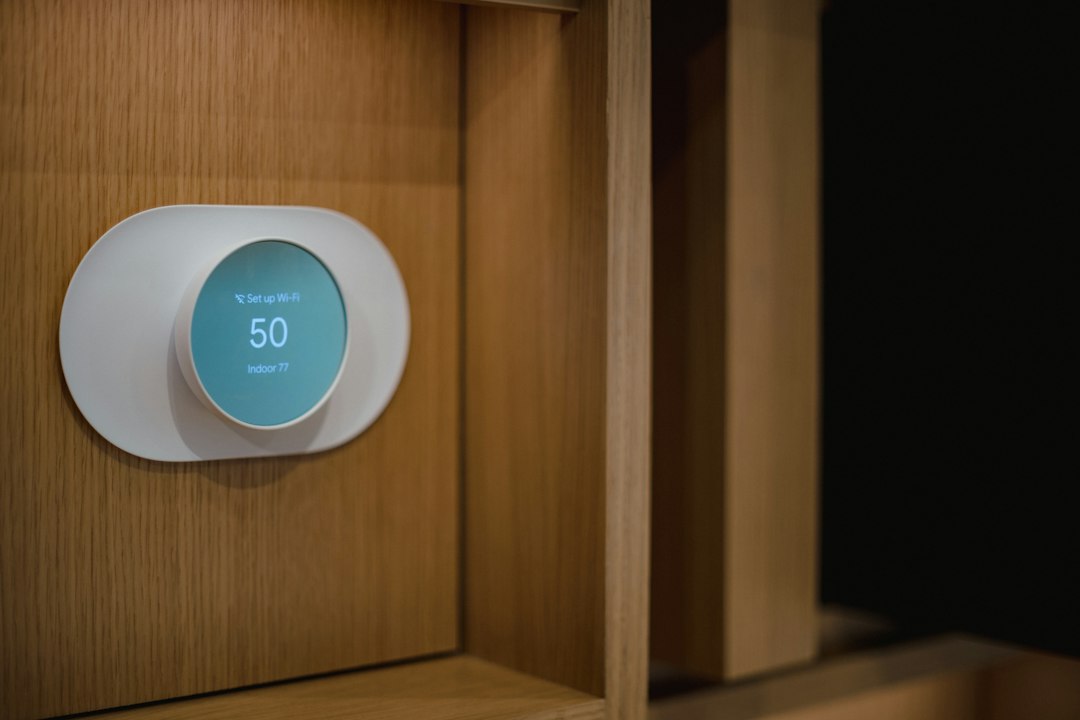 Wall-mounted smart thermostat illustrating Wi-Fi heating and cooling controls